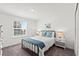 Bedroom featuring a full-sized bed, bedside tables, and a window, with neutral decor and carpeting at 3828 S Atlantic Ave, Daytona Beach, FL 32118