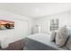 Cozy bedroom with a television, closet, dresser, and a window providing natural light at 3828 S Atlantic Ave, Daytona Beach, FL 32118