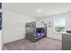 bedroom with bunk beds, a window overlooking the backyard, and neutral carpeting at 3828 S Atlantic Ave, Daytona Beach, FL 32118