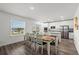 Inviting dining area with a spacious table, ample seating, and an adjacent modern kitchen at 3828 S Atlantic Ave, Daytona Beach, FL 32118