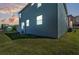 Back exterior view of a two-story home with blue siding, a small deck, and a fenced yard at sunset at 3828 S Atlantic Ave, Daytona Beach, FL 32118