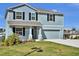Charming two-story home with blue siding, black shutters, and a well-manicured lawn at 3828 S Atlantic Ave, Daytona Beach, FL 32118