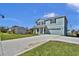 Lovely two-story blue home with an attached garage and lush green lawn in a desirable location at 3828 S Atlantic Ave, Daytona Beach, FL 32118