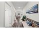 Bright hallway with wood floors, coastal decor, and a bench at 3828 S Atlantic Ave, Daytona Beach, FL 32118