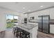 Contemporary kitchen with granite countertops, stainless appliances, and a seamless connection to outdoor living at 3828 S Atlantic Ave, Daytona Beach, FL 32118