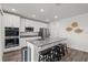 Modern kitchen featuring stainless steel appliances, granite countertops, and a breakfast bar with seating at 3828 S Atlantic Ave, Daytona Beach, FL 32118