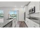 Sleek, modern kitchen with stainless steel appliances, granite counters, and access to a private balcony at 3828 S Atlantic Ave, Daytona Beach, FL 32118