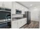 Modern kitchen with stainless steel appliances, granite countertops, and sleek white cabinetry at 3828 S Atlantic Ave, Daytona Beach, FL 32118