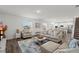 Bright living room with a comfortable sofa, an open floor plan, and stairs at 3828 S Atlantic Ave, Daytona Beach, FL 32118