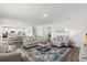 Open-concept living room with ample seating, a decorative rug, and natural light at 3828 S Atlantic Ave, Daytona Beach, FL 32118