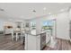 Open-concept living space connecting the kitchen, dining, and living areas, with access to outdoor balcony at 3828 S Atlantic Ave, Daytona Beach, FL 32118
