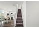 Staircase view leading to the open-concept kitchen and dining room area at 3828 S Atlantic Ave, Daytona Beach, FL 32118
