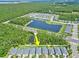 Expansive aerial view showcasing a community with a central lake and lush green surroundings at 5539 Estero Loop, Port Orange, FL 32128