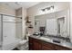 Bathroom features granite countertops, dark wood cabinets, updated fixtures, tub with shower, and neutral colors at 5539 Estero Loop, Port Orange, FL 32128