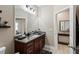 Bathroom with granite countertops, wood cabinets, updated fixtures, and neutral colors at 5539 Estero Loop, Port Orange, FL 32128
