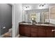 This bathroom features dual sinks with granite countertops, gray walls, a toilet, and an enclosed glass shower at 5539 Estero Loop, Port Orange, FL 32128