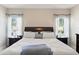 Bright bedroom with hardwood floors, a comfortable bed, and stylish bedside tables with lamps at 5539 Estero Loop, Port Orange, FL 32128