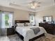 Relaxing primary bedroom featuring tray ceiling, modern decor, and ample natural light at 5539 Estero Loop, Port Orange, FL 32128