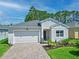 Charming single-story home featuring a two-car garage, paver driveway, and well-manicured landscaping at 5539 Estero Loop, Port Orange, FL 32128