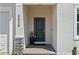 Inviting front entry with a dark-colored door, stone accents, and a well-maintained garden at 5539 Estero Loop, Port Orange, FL 32128
