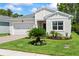 Charming single-story home with a well-manicured lawn, brick driveway, and attached two-car garage at 5539 Estero Loop, Port Orange, FL 32128