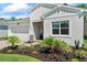 Charming single-story home with a well-manicured lawn, brick driveway, and attached two-car garage at 5539 Estero Loop, Port Orange, FL 32128