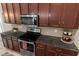 Kitchen featuring granite countertops, stainless steel appliances, and ample cabinet space at 5539 Estero Loop, Port Orange, FL 32128