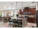 Modern open concept kitchen featuring an island with seating, stainless steel appliances, and pendant lighting at 5539 Estero Loop, Port Orange, FL 32128