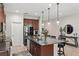 Modern kitchen with granite countertops, stainless steel appliances, and island with seating at 5539 Estero Loop, Port Orange, FL 32128