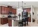 Modern kitchen boasts granite countertops, stainless steel appliances, and a large island with pendant lighting at 5539 Estero Loop, Port Orange, FL 32128