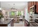 Modern kitchen with stainless steel appliances, granite countertops, and views of dining and living areas at 5539 Estero Loop, Port Orange, FL 32128