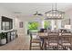 Bright living room featuring an elegant dining table and chairs with open access to outdoor living space at 5539 Estero Loop, Port Orange, FL 32128