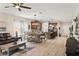 Inviting living room with modern lighting and a spacious layout for dining and relaxing, with hardwood floors at 5539 Estero Loop, Port Orange, FL 32128