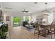 Open-concept living room with a ceiling fan, comfortable seating, and sliding glass doors to the outdoors at 5539 Estero Loop, Port Orange, FL 32128
