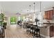 Open-concept living space with kitchen island, dining area, and sliding glass doors to the backyard at 5539 Estero Loop, Port Orange, FL 32128