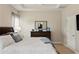 This main bedroom features light hardwood floors and large windows that allow for an abundance of natural light at 5539 Estero Loop, Port Orange, FL 32128