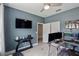 This office features light hardwood floors, blue walls, a ceiling fan, and a wall mounted television at 5539 Estero Loop, Port Orange, FL 32128