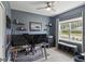 This office features light hardwood floors, a large window, blue walls, and a ceiling fan at 5539 Estero Loop, Port Orange, FL 32128