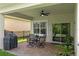 Relaxing covered patio with brick pavers, ceiling fan, and outdoor seating area at 5539 Estero Loop, Port Orange, FL 32128