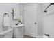Bathroom with white vanity, modern fixtures, and a well-lit mirror at 603 W Miles St, Deland, FL 32720