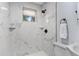 Modern bathroom showcasing marble tile shower with black hardware and a toilet at 603 W Miles St, Deland, FL 32720