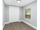 Bedroom featuring laminate flooring, double door closet, and a window at 603 W Miles St, Deland, FL 32720