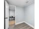 Cozy bedroom with open doorway to another room, laminate flooring, and neutral paint at 603 W Miles St, Deland, FL 32720