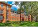 Brick building with green lawn and shade trees at Stetson University at 603 W Miles St, Deland, FL 32720