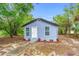 Charming home exterior features a blue facade, updated windows, and a walkway to the entrance at 603 W Miles St, Deland, FL 32720