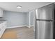 Updated kitchen with stainless steel refrigerator and gray laminate flooring for a sleek and modern design at 603 W Miles St, Deland, FL 32720