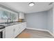 Clean kitchen featuring white cabinetry, modern appliances, and neutral color scheme at 603 W Miles St, Deland, FL 32720