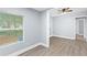 Open-concept living room with laminate floors, large window, and gray walls at 603 W Miles St, Deland, FL 32720