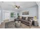 Comfortable living room showcasing a large sectional sofa, ceiling fan, and stylish accents at 603 W Miles St, Deland, FL 32720