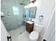 Modern bathroom with a glass-enclosed shower, wood vanity, and stylish fixtures at 68 Hibiscus Dr, Ormond Beach, FL 32176